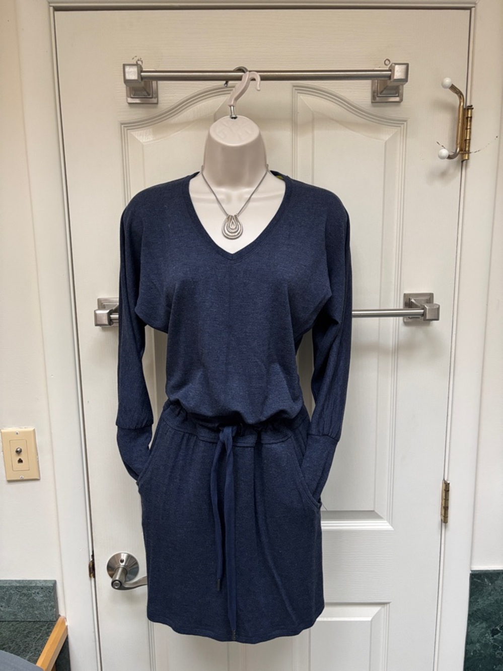 navy blue Athleta long-sleeve jersey dress with a v-neck and drawstring waist.